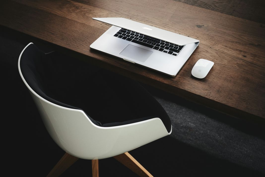 Minimalist workspace featuring compact wooden desk with rounded edges. Perfect for focused work zones or individual hot desk setups.